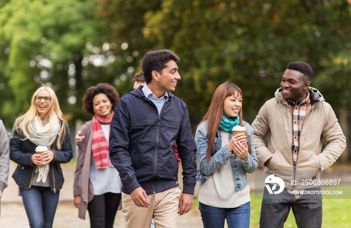 happy friends walking along autumn park