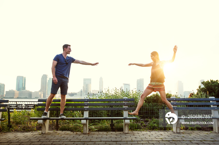 Couple standing on bench face to face