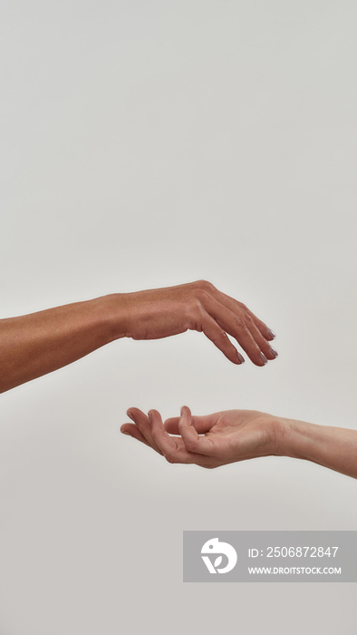 Close up of two open cupped hands with empty space between them isolated over light background