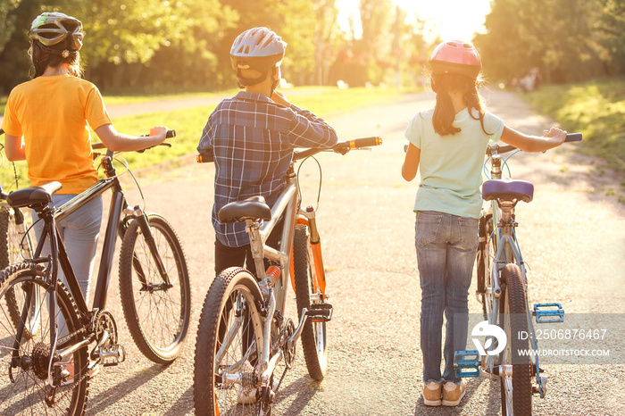 Cute children riding bicycles outdoors