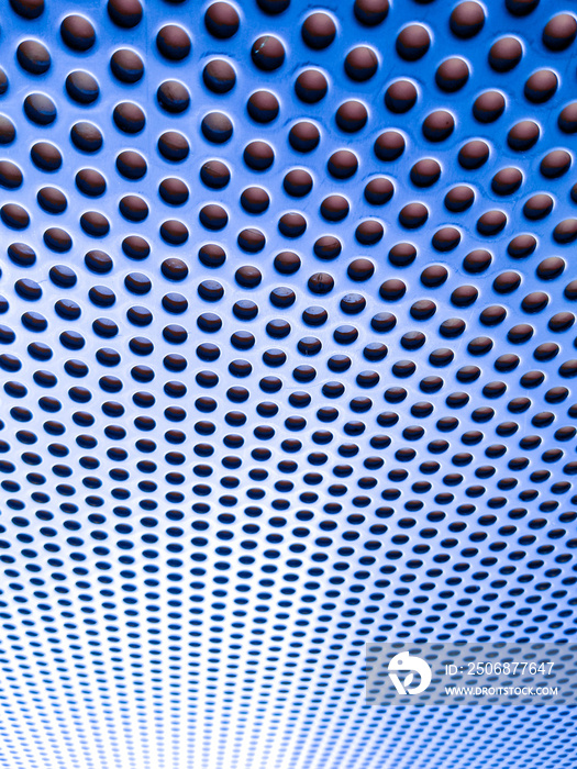 Blue perforated sheet, blue steel perforated plate in the background.