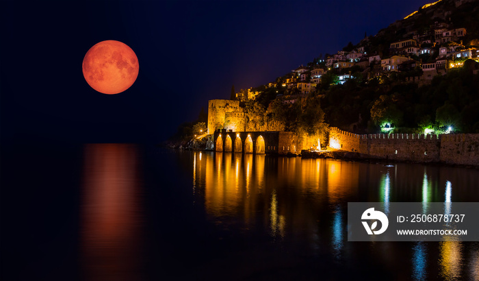 Night view of ancient shipyard with full moon - Alanya, Turkey   Elements of this image furnished by