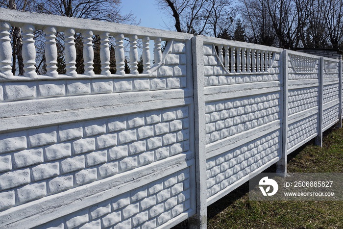 long white concrete fence outside in green grass