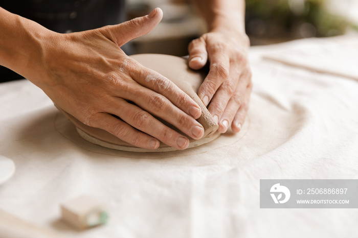 Close up of a woman making ceramic and pottery