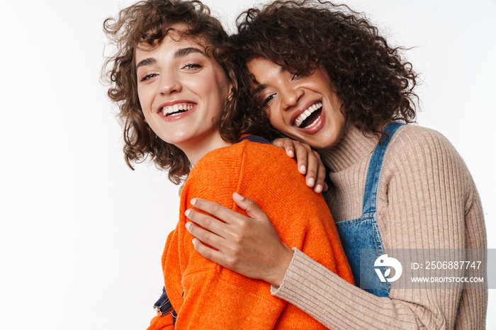 Portrait of excited multinational women laughing and hugging