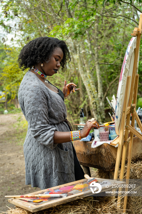 female artist with her palette and canvas