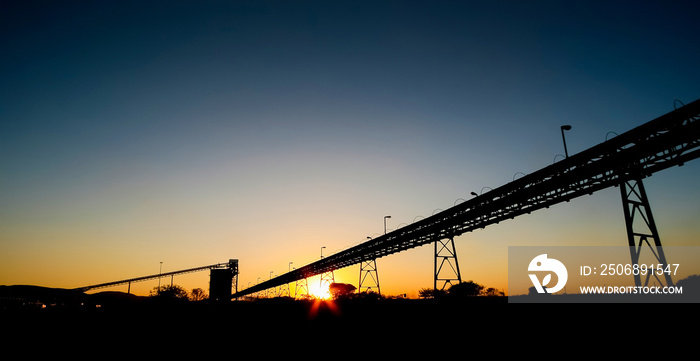 Silhouette of a mining silo and conveyor belts