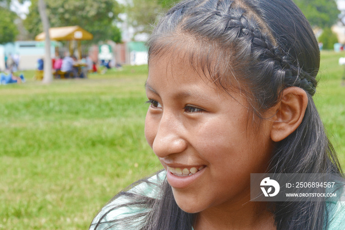 Native american girl laughing outside.