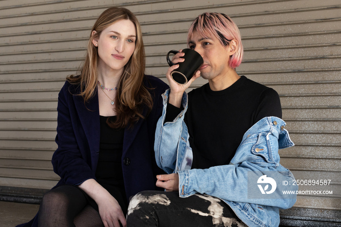 Lgbtqia friends sitting and posing together.