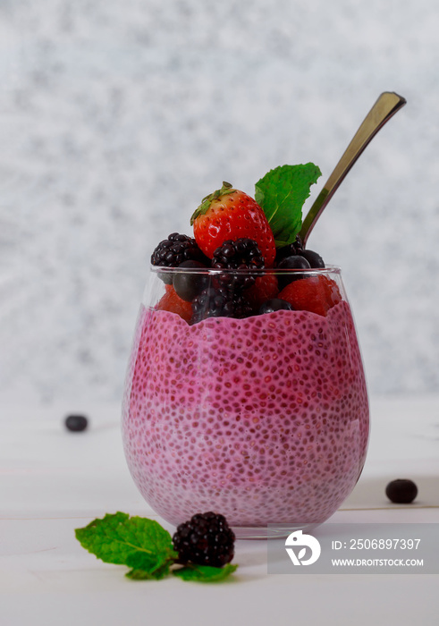 Healthy breakfast with strawberries, chia seeds pudding with blueberries in a glass