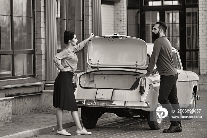 Couple in love near the car in retro style