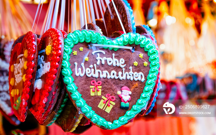 Heart shape Gingerbread cookies food on Christmas market in Europe in winter. German Night street Xm