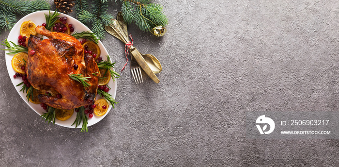 Christmas table with baked chicken is festively decorated with candles. top view