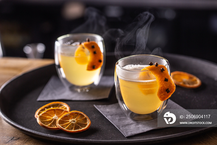 HOT TODDY drink made of whiskey, simple syrup, hot water, cloves and orange zest ready for customers