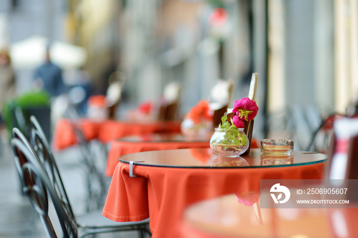 Beautifully decorated small outdoor restaurant tables in the city of Lucca, Italy