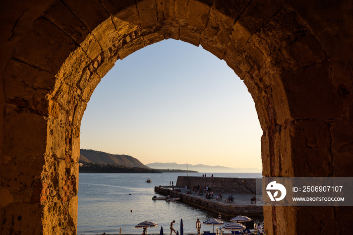 Arch overlooking the sea in the medieval town of Cefalù, Sicily, Italy