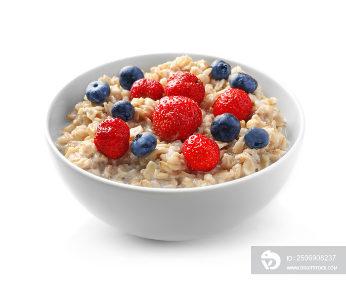 Bowl with yummy oatmeal and berries against white background