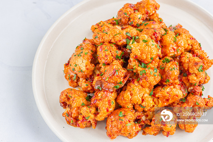 Buffalo Cauliflower Bites on a White Plate Top View Photo