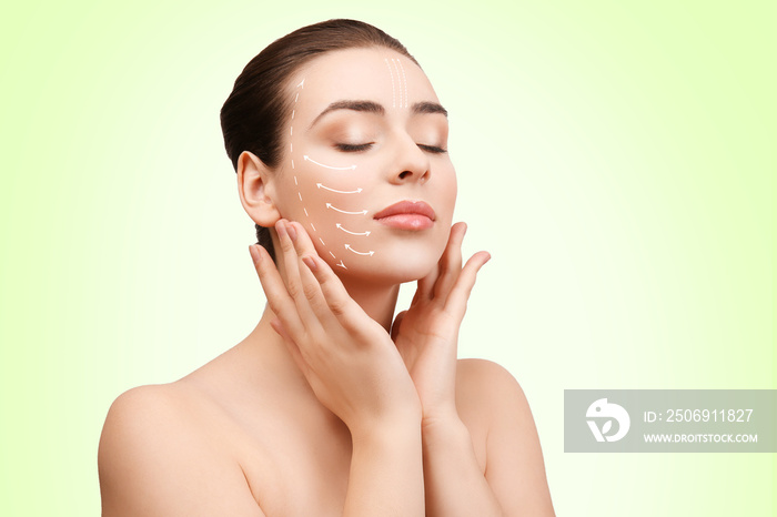Plastic surgery concept. Young woman with marks on face against light green background
