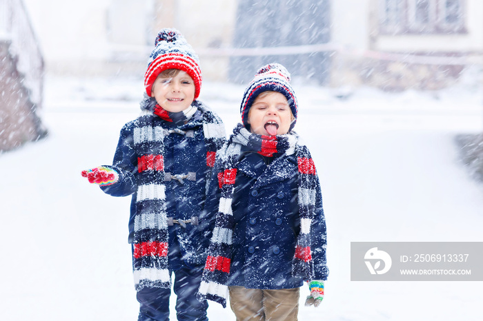 Happy children having fun with snow in winter