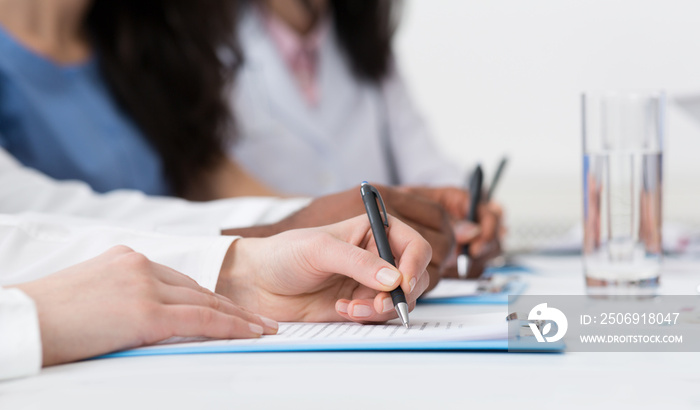 Medical Education. Doctors Writing On Paper At Conference