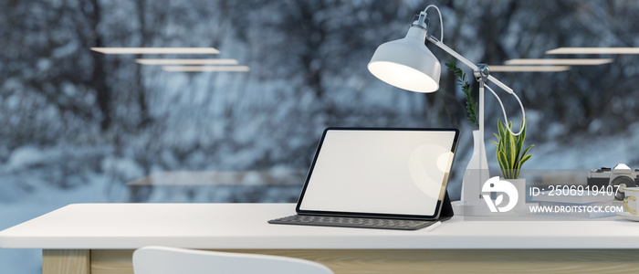 Tablet mockup on top table over blurred winter snow through the glass window