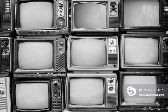 Pattern wall of pile black and white retro television (TV) - vintage filter effect style.