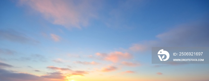 Clear blue sky with glowing pink and golden clouds after the storm. Dramatic sunset cloudscape. Conc