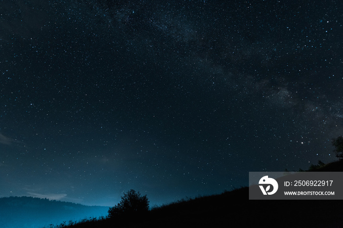 milky way with shining stars on blue sky at night