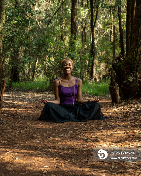 woman laughing while in the lotus pose