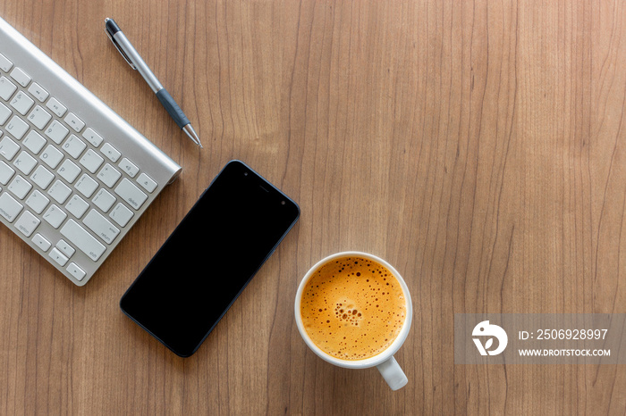 business concept. top view of office desk workspace with smartphone, pen, keyboard, glasses and hot 