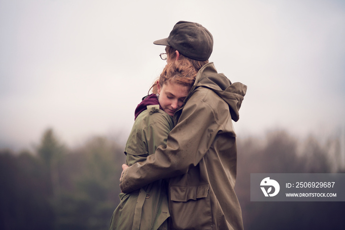 Young hikers embracing