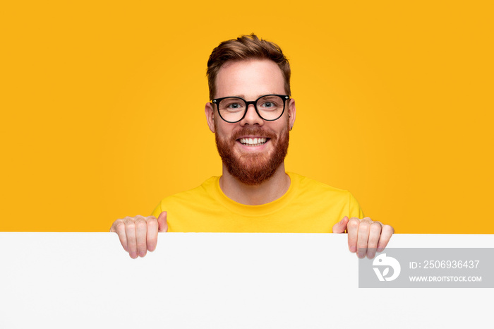 Happy bearded man with empty banner