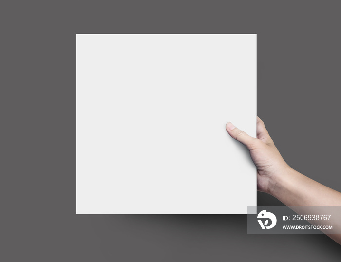 Woman hand holding blank paper sheet or design paper on black background.