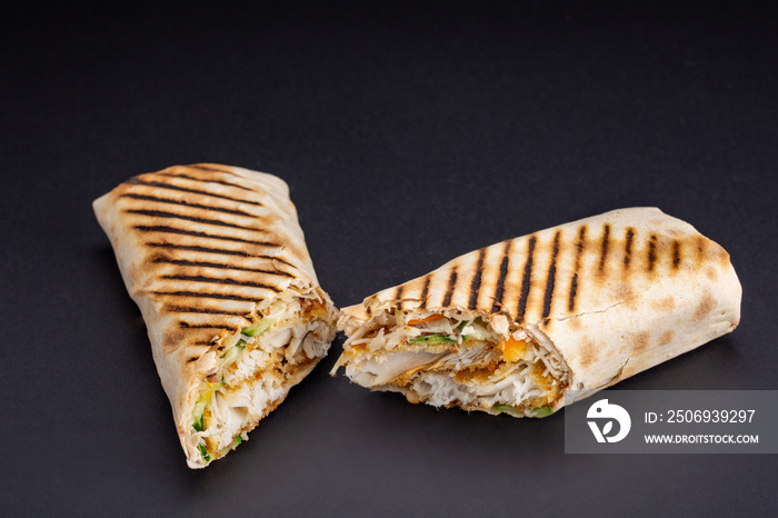 Shawarma sandwich - fresh roll of thin lavash or pita bread filled with grilled meat, mushrooms, che