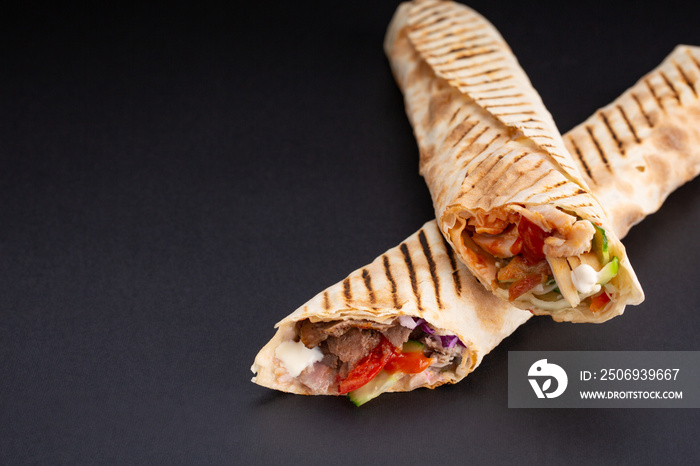 Shawarma sandwich - fresh roll of thin lavash or pita bread filled with grilled meat, mushrooms, che