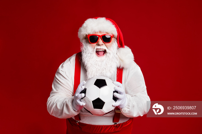 Portrait of his he attractive cheerful cheery ecstatic fat white-haired Santa holding in hands socce