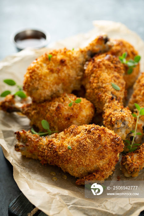 Panko breaded fried chicken drumsticks with hot honey sauce