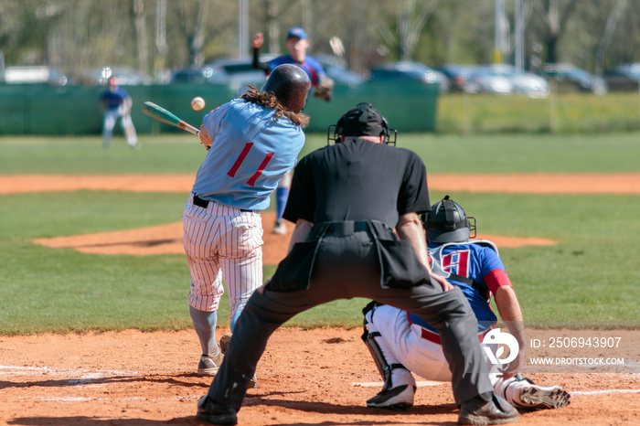 Baseball batter hits ball