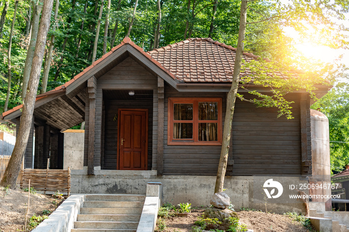 House of the log. House of extruded wooden profile in the forest.