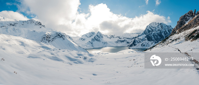 Panoramic view on a snow hiking trip in the Alps. Luenersee in the heart of the Raetikon Mountains, 