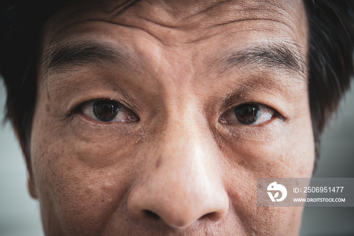 Detail of facial of Asian old man close up. processed in vintage color tone.