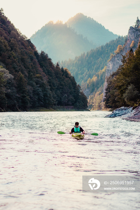 Young man kayaking on the Dunajec river