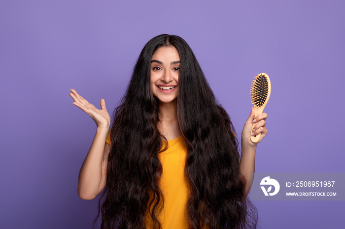 Smiling Young Indian Woman With Long Hair Holding Wooden Comb