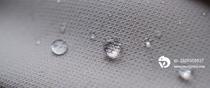 water beading on fabric. Waterproof coating background with water drops. soft focus, blur