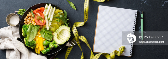 Vegan healthy balanced diet. Vegetarian buddha bowl with blank notebook and measuring tape. Сhickpea