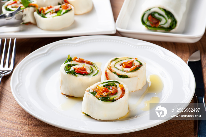 .Buffalo mozzarella roll stuffed with dried tomatoes and arugula.