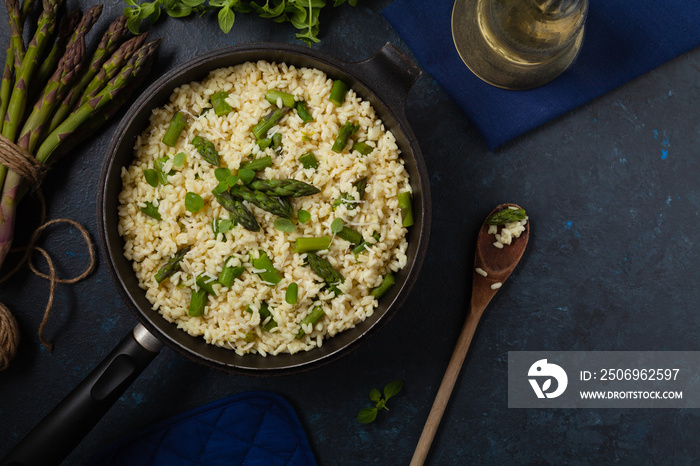 Classic Italian risotto with asparagus. Top view. Darkblue background.