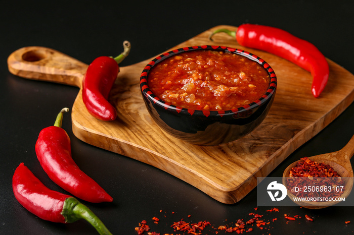 Traditional Maghrebi hot chili pepper sauce paste harissa on dark background, Tunisia and Arabic cui