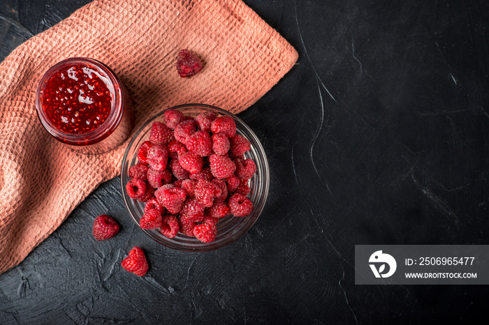 raspberry jam and raspberries. Dark food photo.